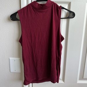 Soft sleeveless mock turtleneck top; maroon; size small.